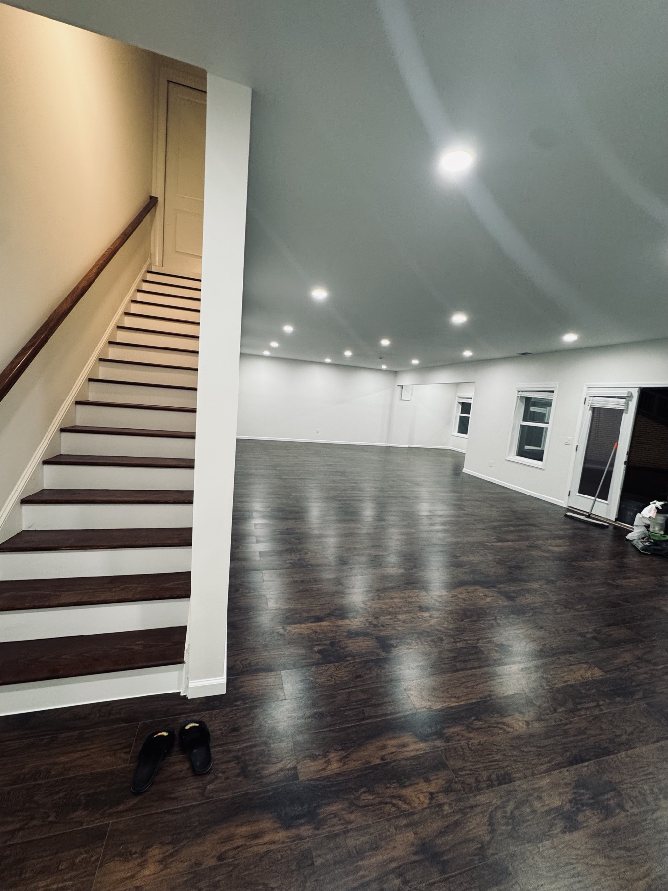 Finished basement wide view with staircase and walkout door