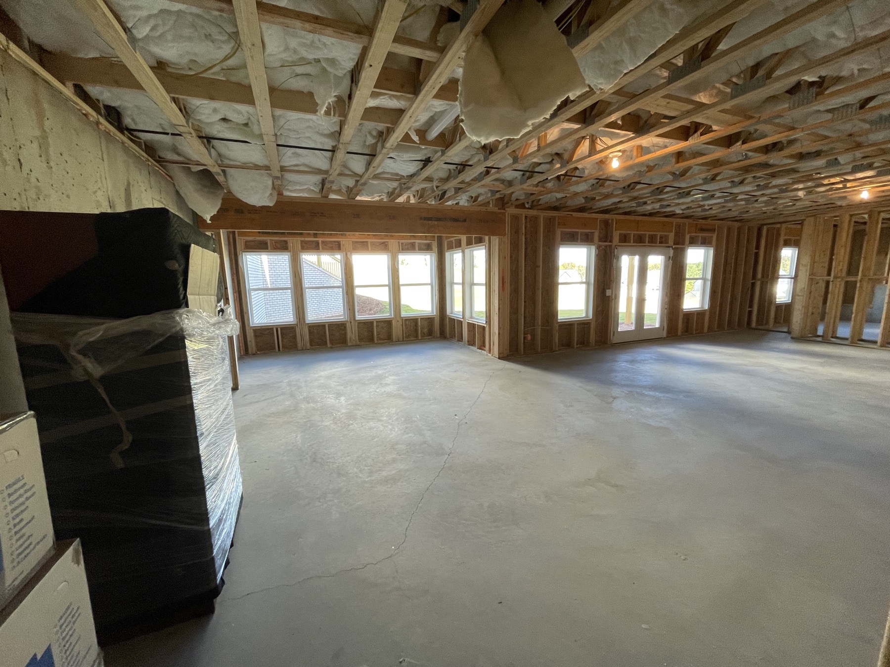 Unfinished basement bay window wall, wide view