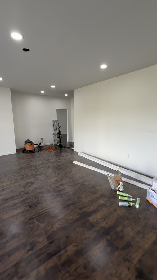 Flooring being installed, walls primed white