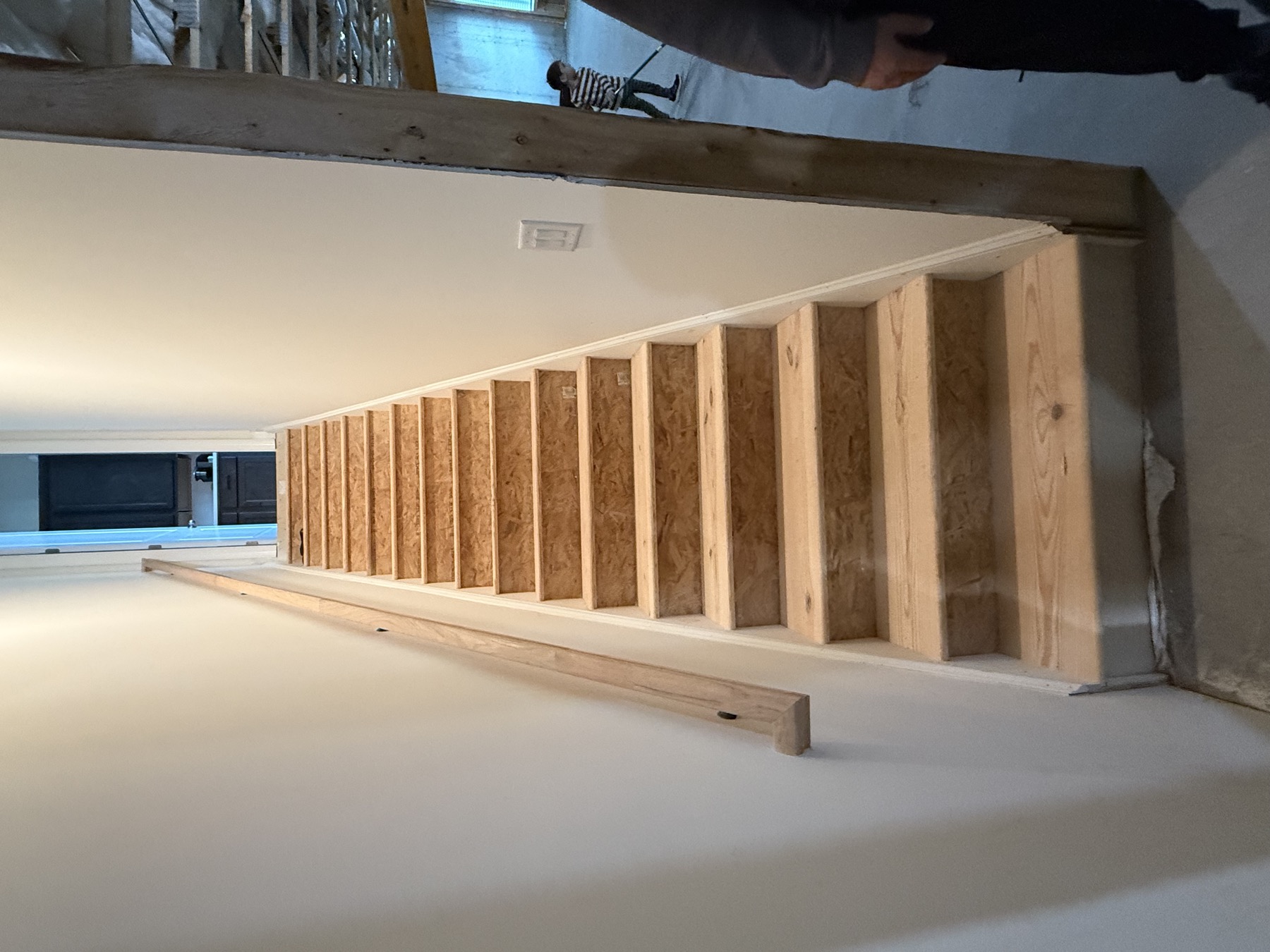 New basement staircase under construction with plywood treads