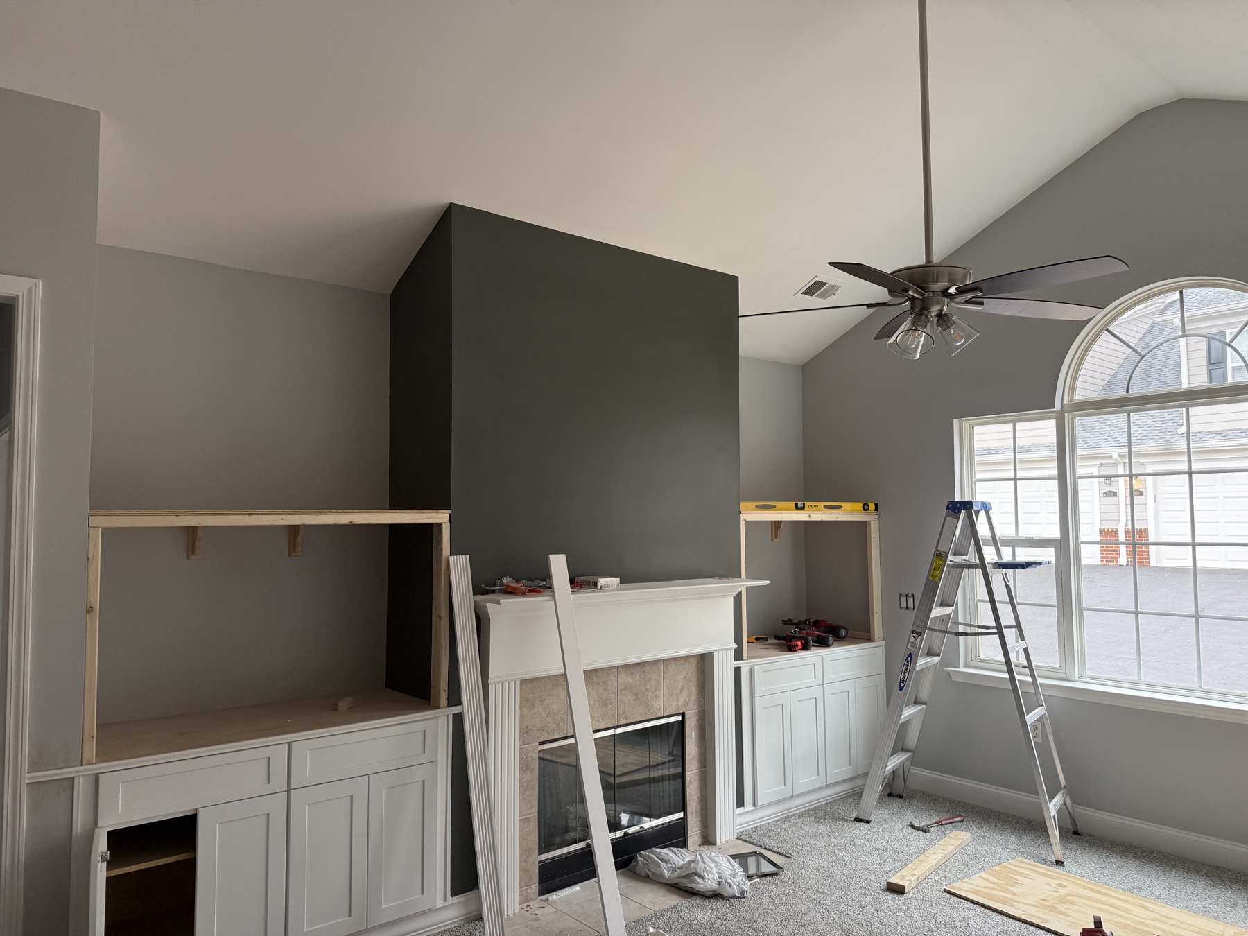 Fireplace built-in cabinetry and accent wall under construction