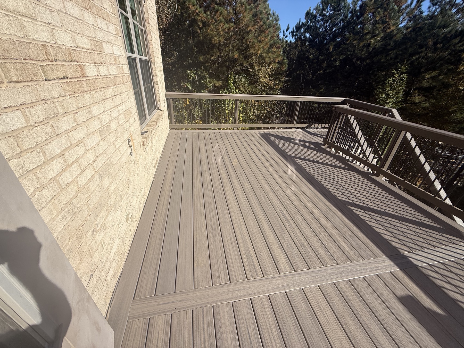 Elevated deck with cable rail and tree-line view