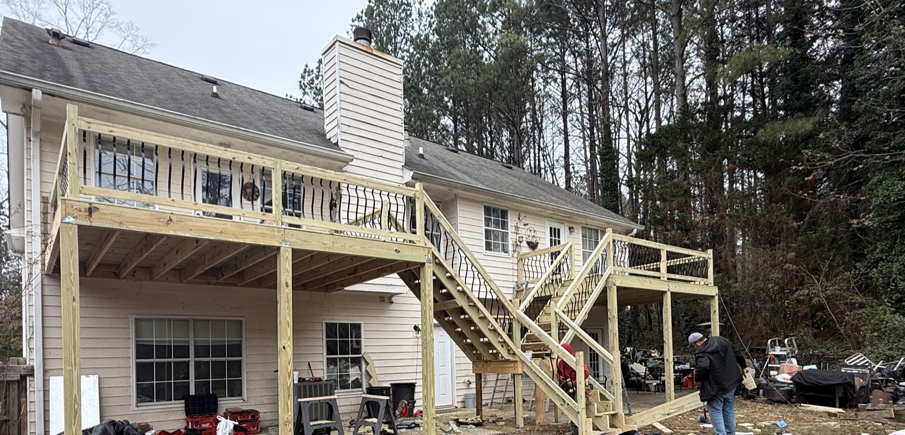 New deck framed with black rod railing after rebuild