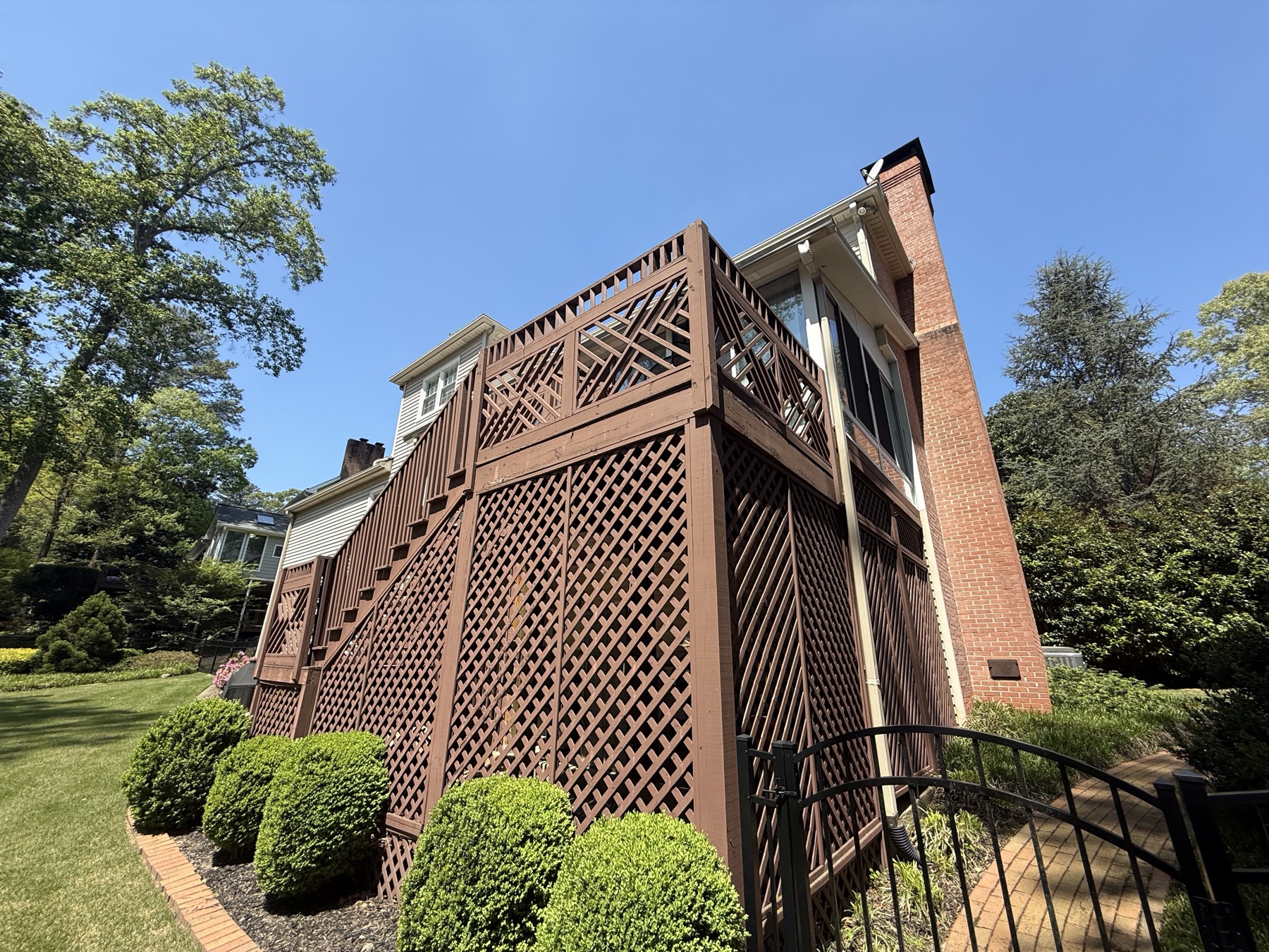 Old deck with brown lattice skirting before rebuild