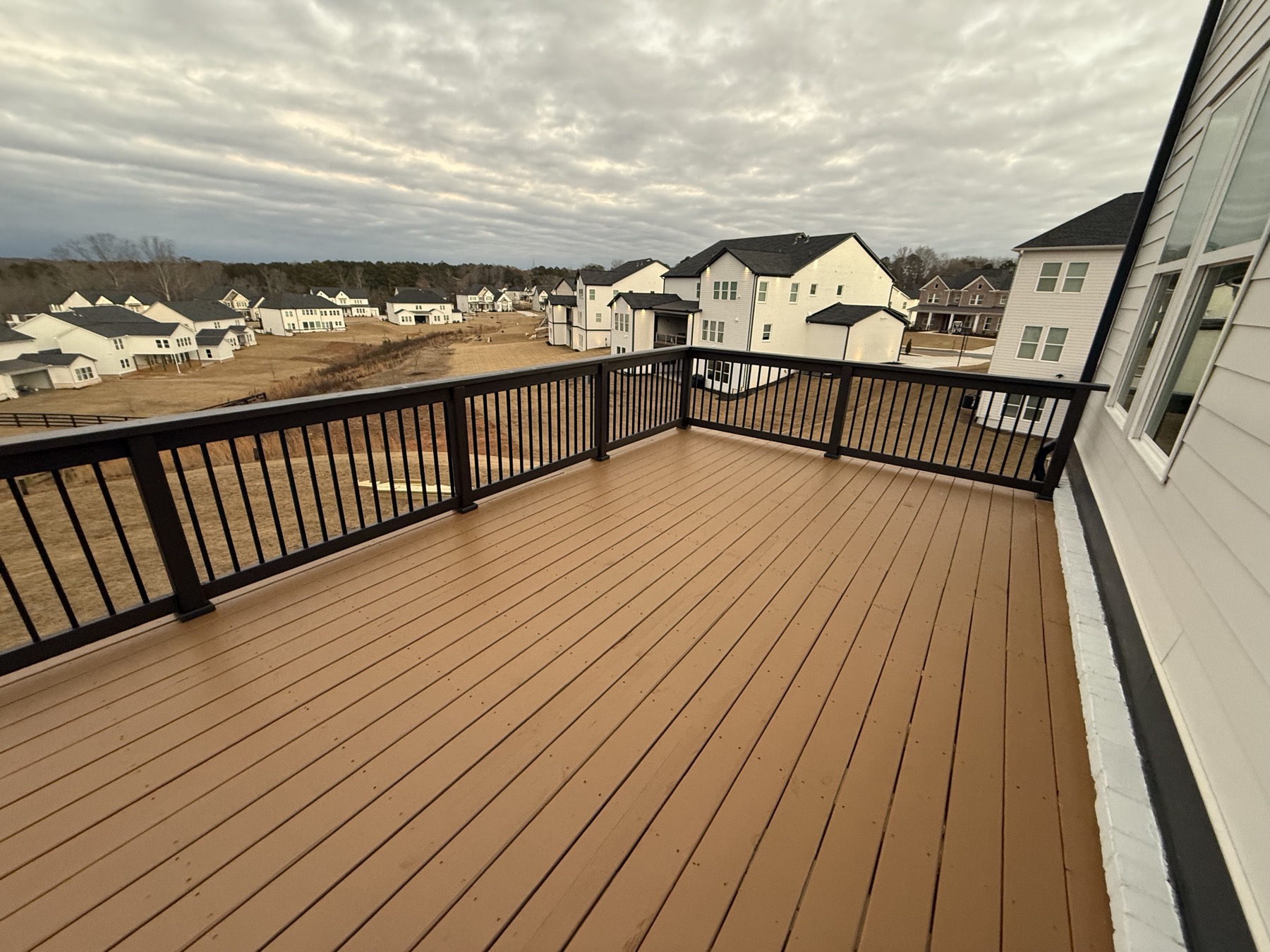 Restained deck surface with black railing