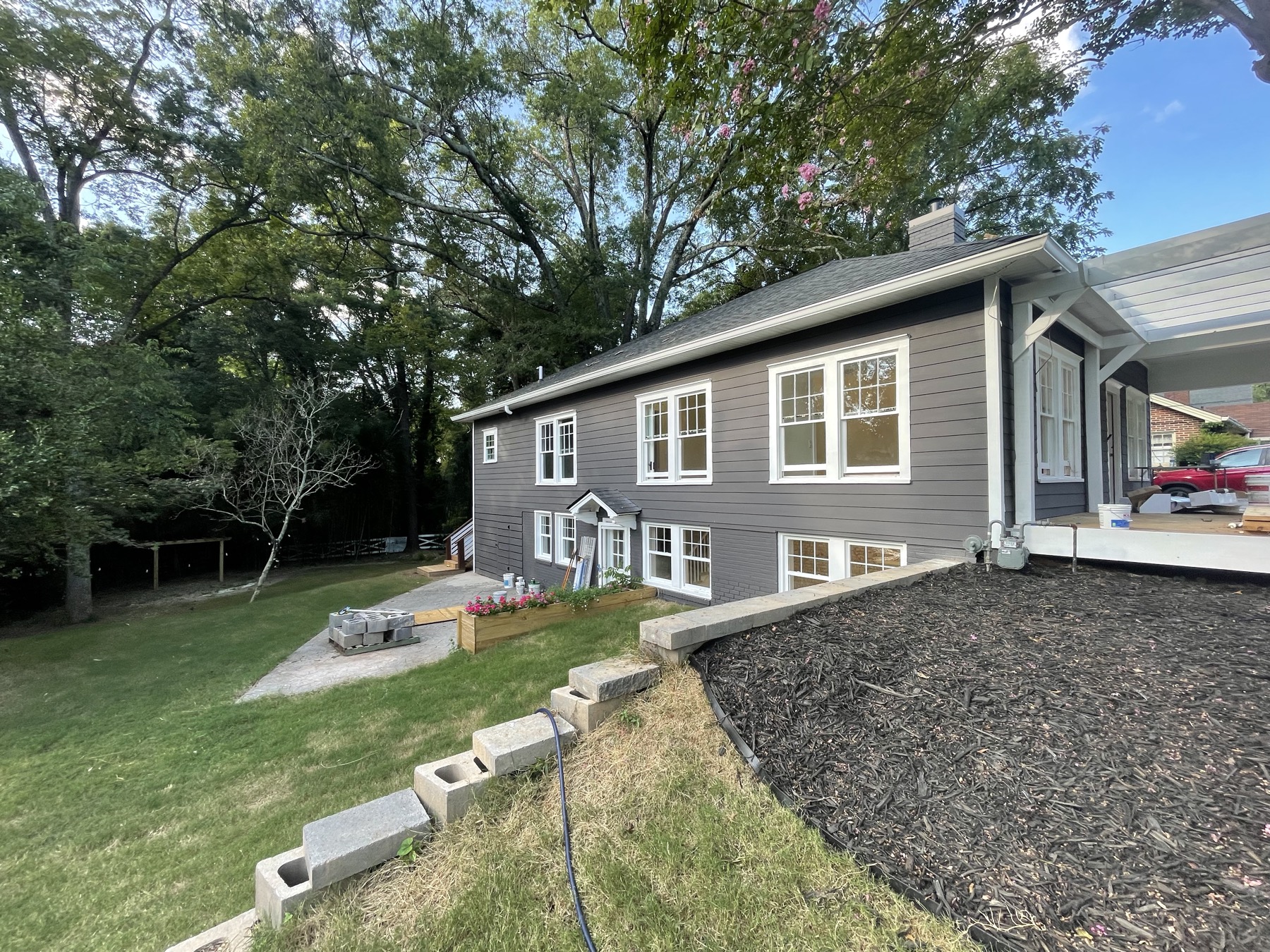 Home exterior repainted a deep charcoal navy with white trim