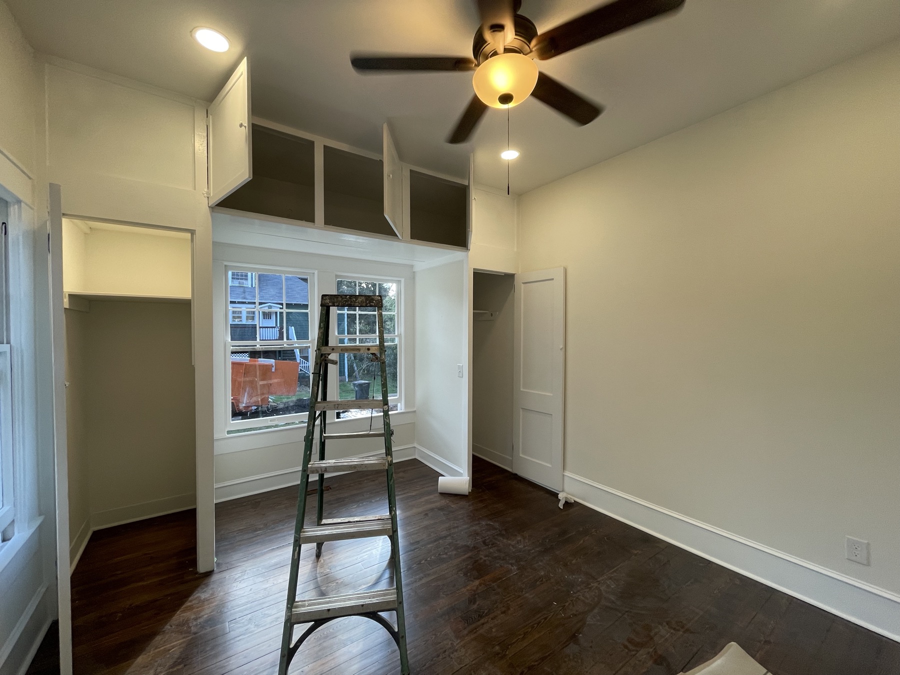 Finished room with built-in cabinetry and walk-in closet