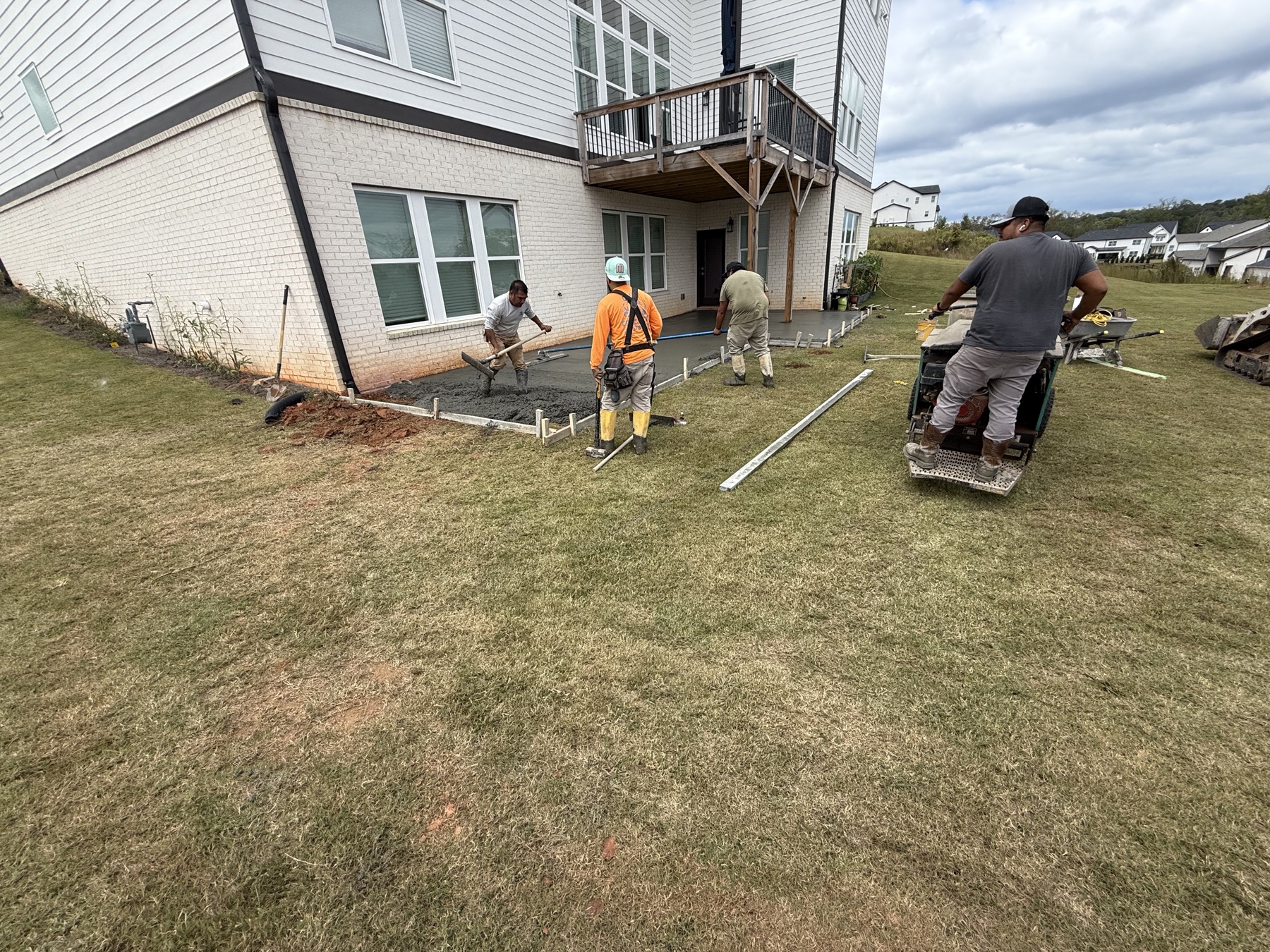 Crew pouring concrete patio
